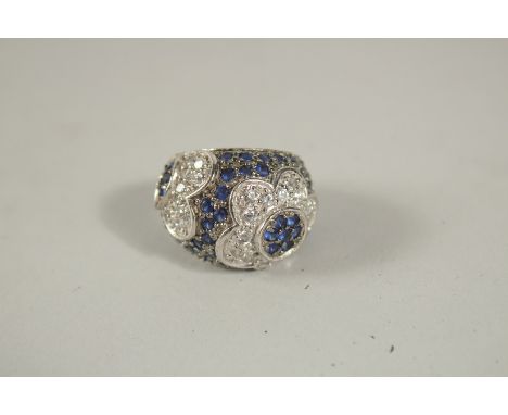 A GOOD SILVER DIAMANTE AND BLUE STONE RING, boxed.