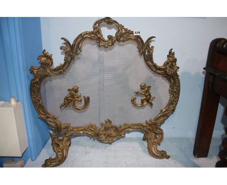 A Continental ornate and wire mesh fire screen, 73cm wide, 70cm height