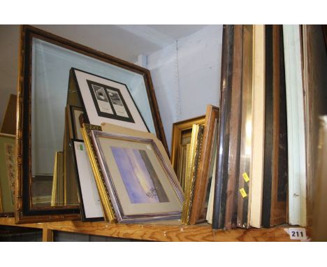 A shelf of framed paintings, prints etc.