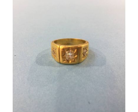 An unmarked gold coloured ring, mounted with three diamonds, 10.7g