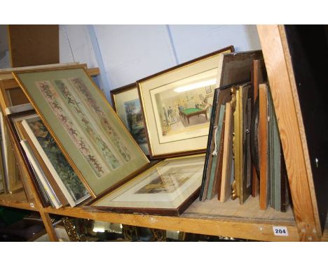 A shelf of framed pictures and prints