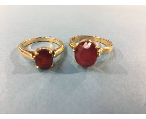 Two rings, stamped 750 and 18k, both mounted with ruby coloured stones, 9.4g