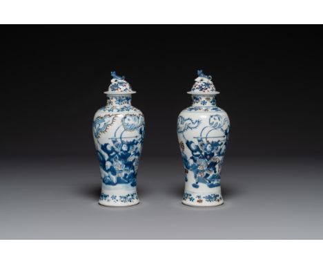 A pair of Chinese blue, white and copper-red vases and covers, Kangxi mark, 19th C. H.: 27,5 cm (incl. cover)