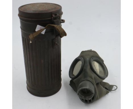 German WWII Luftshutz issue gas mask in cylindrical cannister, with a British military issue gas mask in canvas satchel (2). 