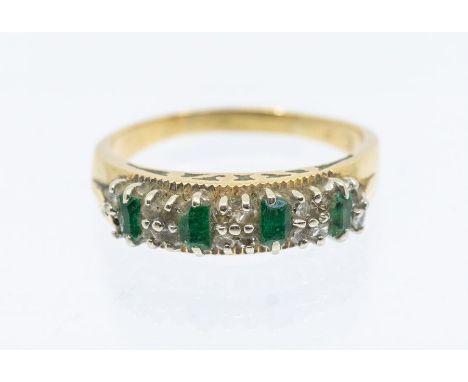 An emerald and diamond 18ct gold dress ring, set with four baguette cut emeralds with diamond set accents, width approx 6mm, 