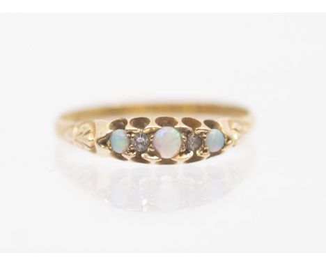 A 22ct gold opal and diamond set boat ring, set with three round opals, with diamond accents, scolled setting  size R, total 