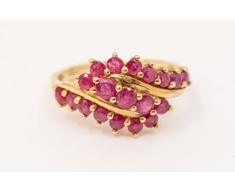 A ruby and 9ct gold cluster ring, comprising three claw set rows of round cut ruby decoration, width approx 12mm, size R, tot