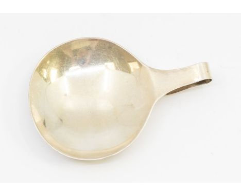 A George V large plain oval shaped caddy spoon with turn over handle, hallmarked by Roberts &amp; Belk, Sheffield, 1923, engr