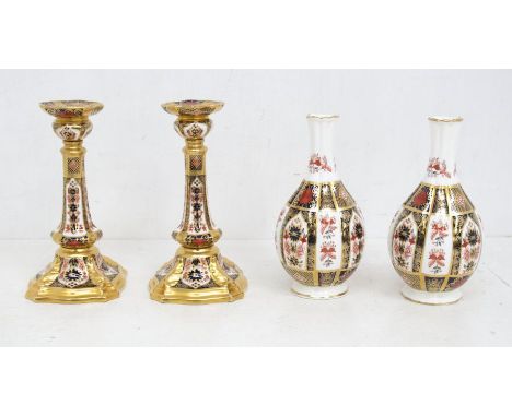 A pair of Royal Crown Derby Imari 1128 pattern candlesticks, a pair of Old Imari vases, both first quality and in good condit