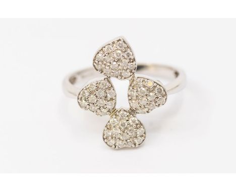 A diamond and 9ct white gold cluster ring, comprising four heart shaped clusters, pave set with small diamonds, setting appro