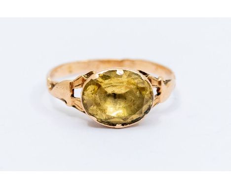 A Georgian stone citrine and gold ring, comprising an oval faceted mixed cut citrine in a closed back cut down setting, appro