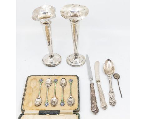 A collection of silver to include: two weighted bud vase (one has broken foot); a letter opener; a silver handled knife; a Vi