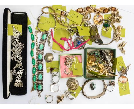 A collection of costume jewellery to include paste set brooches, silver lily pad brooch, cameos, portrait gilt brooch, white 