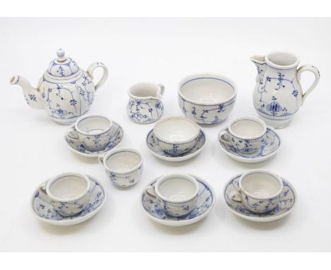 A miniature Continental tea set, decorated with Periwinkle teapot, hot water jug, milk, sugar six cups and saucers, waste bow