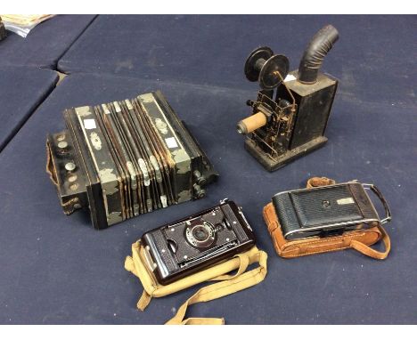 A collectors lot to include an early 20th Century projector, early 20th Century squeeze box, two mid 20th Century vintage cas
