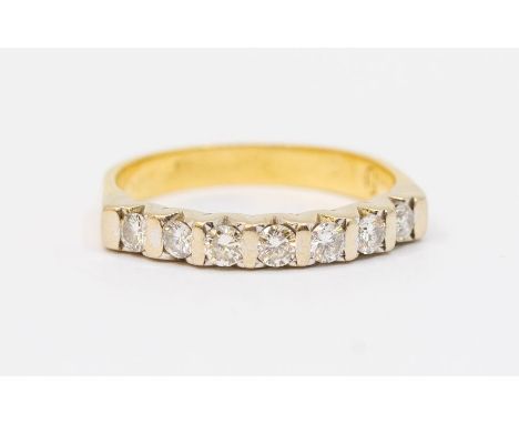 A diamond set 18ct gold half eternity ring, comprising seven bar set brilliant cut diamonds, total diamond weight approx 0.35