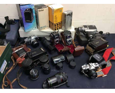 A collection of mid 20th Century cameras with cases by Yashica, Kodak etc along with accessories including tripod, lenses