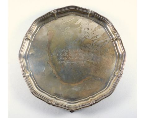 Silver presentation shaped circular salver with a reeded and floral piecrust rim and inscription ?Presented to Mr and Mrs Ber