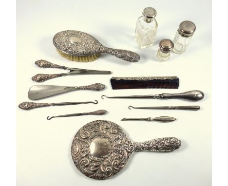 Three piece silver dressing table set comprising a hand mirror, hair brush and comb, by Broadway &amp; Co., Birmingham 1981 a