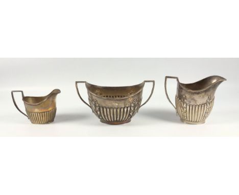 Edwardian silver oval 2 handled sugar basin with semi-fluted and foliate decoration, and a milk jug en suite, by Goldsmiths &