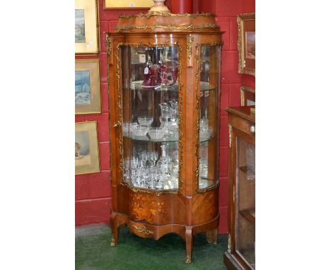 A Louis XV Revival gilt metal mounted kingwood and marquetry bombe shaped vitrine, caddy top above a glazed door, the base in