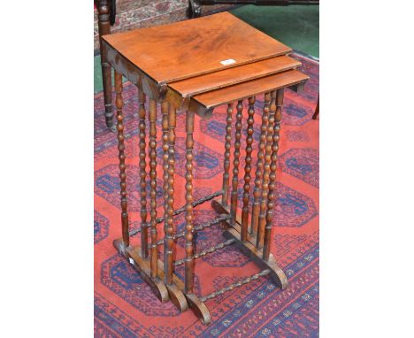 An early 19th century mahogany nest of three tables, rectangular top, bobbin turned supports and stretchers.