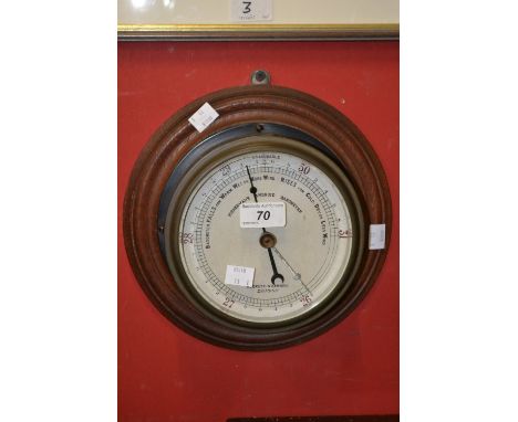 A circular Negretti Fisherman's Aneroid Barometer, on oak mount