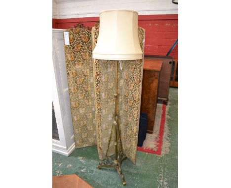 A brass telescopic standard lamp, tubular column, twisting rails, tri-form base
