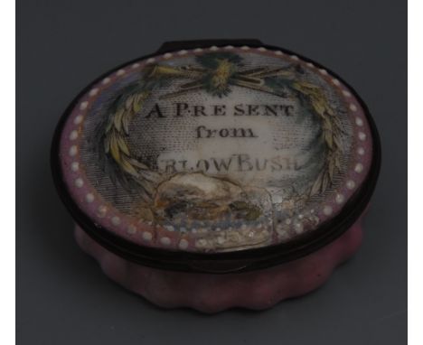 A George III South Staffordshire enamel oval patch box, the hinged cover decorated with a musical trophy and inscribed A Pres