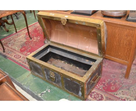 A large brass and copper log box in the form of a dome top trunk. 82cm high x 90.5cm wide.