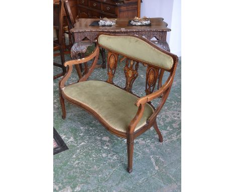 An Edwardian mahogany two seat salon sofa, cresting padded back rail, pierced vasular splats inlaid urns and swags, open arms