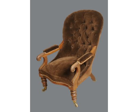 A William IV mahogany armchair, deep-button stuffed-over upholstery, padded arms terminating in boldly carved lotus scrolls, 