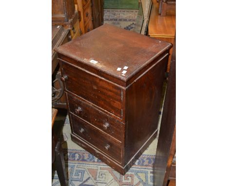 A Victorian mahogany bedside cabinet, single door cupboard over two drawers, button handles.