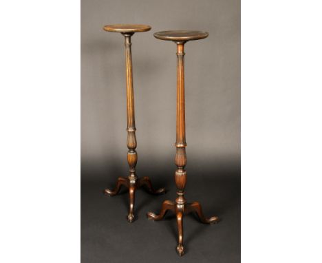 A pair of George III style torchere stands, dished circular tops, tapered fluted acanthus carved vasular columns, cabriole tr