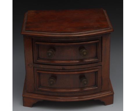 A late 19th century mahogany bow fronted table top chest, moulded top above two drawers, brass drum handles, skirted base, br