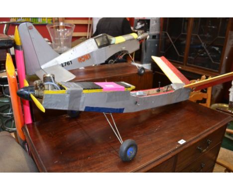 Toys and Juvenalia - a petrol engine single wing model aeroplane; another smaller; spare engines; tools etc 