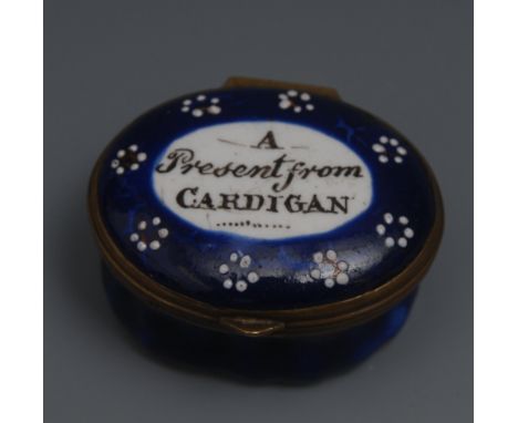 A George III South Staffordshire enamel oval patch box, hinged cover inscribed A Present from Cardigan, within an oval reserv
