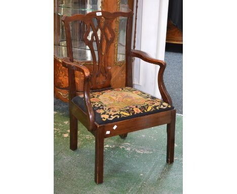 A Chippendale style carver chair, shaped top rail, pierced vasular splat, shaped outswept open arms, drop in embroidered seat