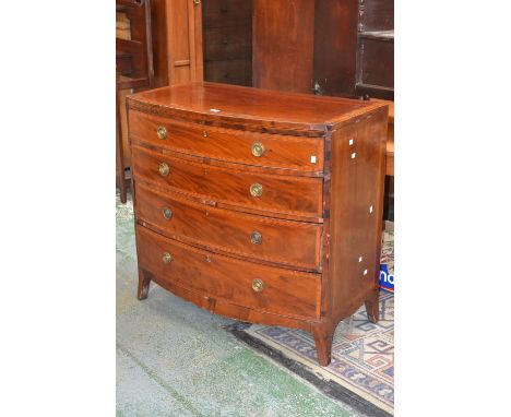 A George III mahogany bow front chest, banded top over four graduated satinwood banded drawers, brass escutcheons, loop handl