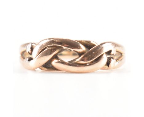 A hallmarked 9ct rose gold knot ring. The ring having an open knot design to the head with pierced shoulders &amp; tapering b