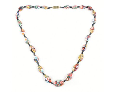 A vintage mid 20th Century millefiori glass beaded necklace. The necklace having oval millefiori beads spaced with further bl