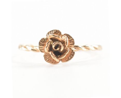 A hallmarked 9ct yellow gold rose ring. The ring having a textured rose to the centre on a twisted shank. Hallmarked for Birm