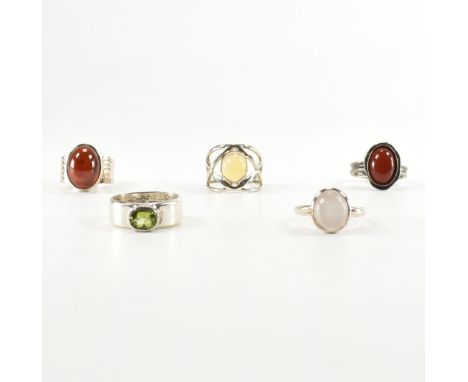 A collection of five 925 silver rings. The rings to include garnet set moonstone, opal, carnelian, peridot&nbsp; set. Most ma