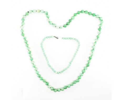 Two vintage strings of jade &amp; green hard stone beads. The first of uniform spherical jade beads having various shades of 
