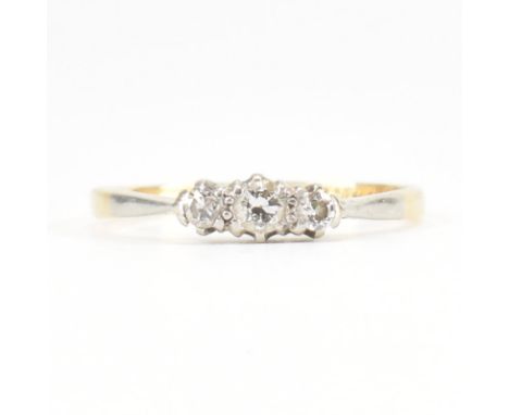 An early 20th Century 18ct gold platinum and diamond three stone ring. The ring set with three graduating round brilliant cut