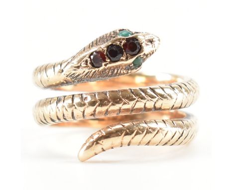 A vintage 9ct yellow gold &amp; stone set snake ring. The ring in the form of a coiled snake having opaque green cabochons to