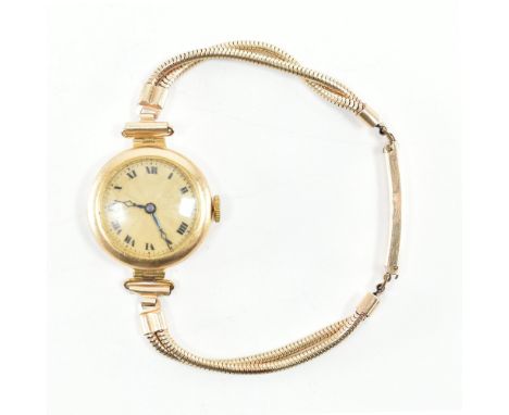 A hallmarked 1920s hallmarked 9ct gold watch. The watch having Roman numerals to engine turned champagne dial having 15 jewel