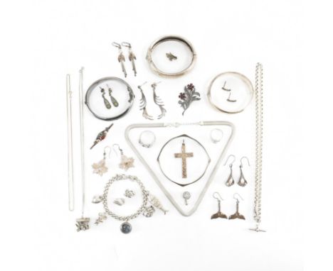 A collection of assorted silver and white metal jewellery. The lot to include a silver charm bracelet with charms, a silver b