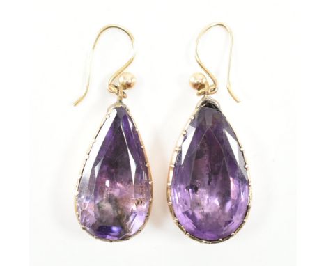 A pair of 19th century amethyst drop earrings. The earrings set with large pear cut amethyst in a closed foil backed mount to