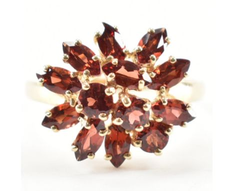 A hallmarked 9ct gold and garnet cluster ring. The ring being set with marquise cut garnets. Hallmarked Birmingham 2007. Weig